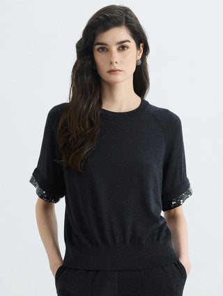 Black wool-silk knit top with silver bead cuffs and short sleeves, crew neck