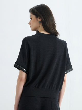 Black wool-silk knit top, back view with silver beaded cuffs on short sleeves