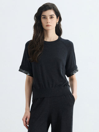Black wool-silk knit top with silver bead trim cuffs, short sleeves and straight hem