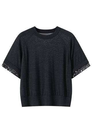 Black wool-silk knit top flat lay with silver beaded sleeve cuffs and crew neckline