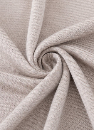 Beige knit fabric close-up with soft drape and fine texture