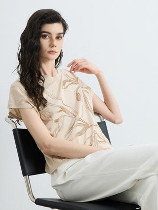 Apricot knit top with leaf embroidery detail and crew neck, short sleeves