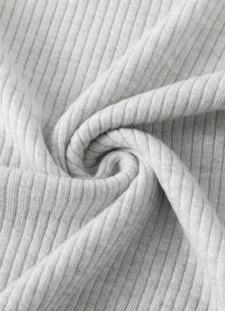 Pale taupe knit fabric close-up with ribbed texture and soft folds