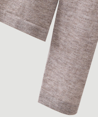 Taupe wool-blend knit turtleneck top, ribbed hem close-up.