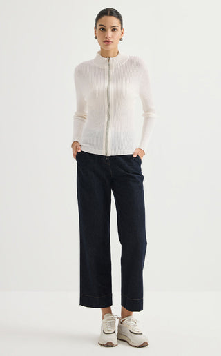 Fine wool ribbed zip cardigan in off-white, worn with dark jeans; slim ribbed silhouette