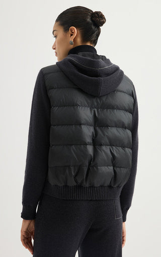 Black hooded puffer jacket back view with quilted yoke and ribbed hem