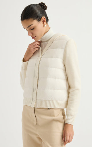 Cream hooded puffer jacket with ribbed hem, snap front, and long knit sleeves