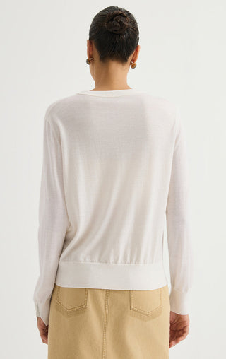 Women’s fine wool crewneck sweater in white, back view with cuff detail and long sleeves.