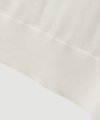 White fine wool knit sweater sleeve and ribbed cuff texture detail