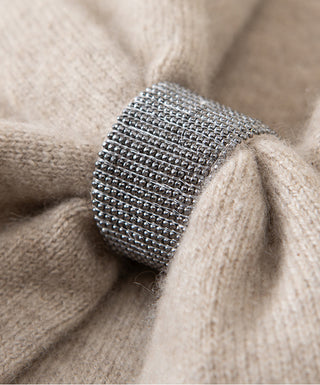 Metal mesh detail near bow on ivory cashmere knit fabric