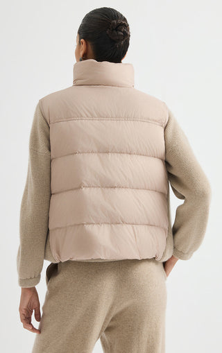 Camel puffer vest back view with quilted panels and stand collar.