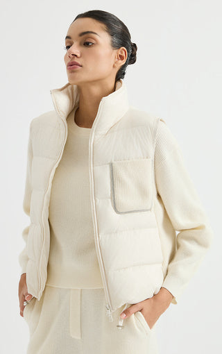 Ivory white quilted down puffer vest with stand collar and front zip, chest pocket visible.
