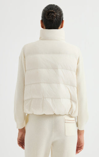 Ivory white puffer vest back view with quilted horizontal panels and stand collar.