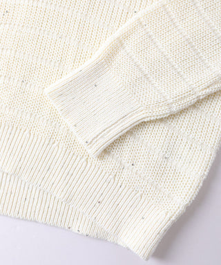 White knit pullover cuff close-up with fine sequins along the ribbed edge