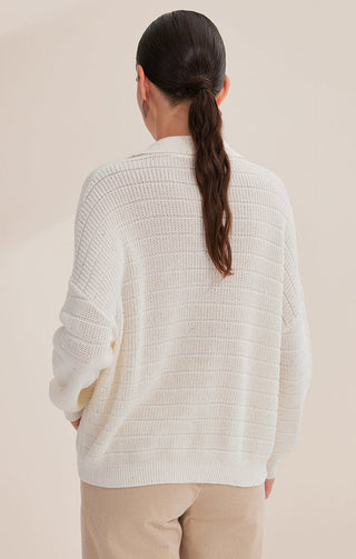 Back view of white textured cotton knit pullover with fine sequins