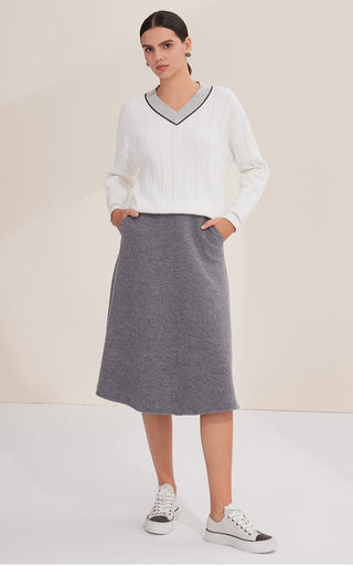 White V-neck contrast-trim cotton sweater on model, long sleeves and ribbed neckline