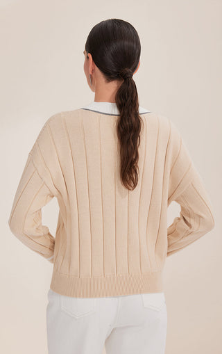 Apricot cotton sweater back view with vertical knit stripes and ribbed waistband