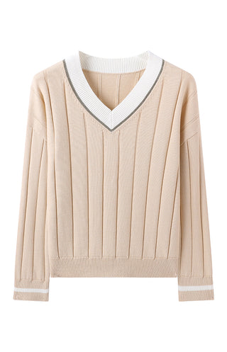 Apricot sweater flat lay: V-neck with white contrast trim and vertical knit stripes