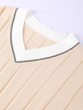 Apricot V-neck collar close-up with white trim and dark outline band