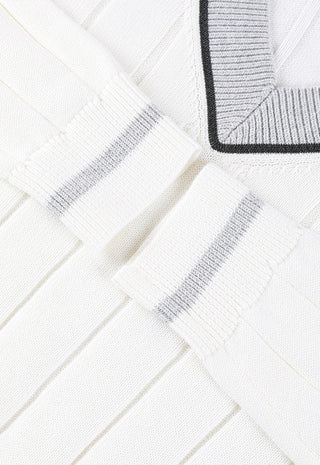 White sweater sleeve cuff close-up with ribbing and contrast stripe at edge
