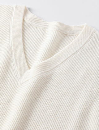 White V-neck knit sweater neckline with ribbed texture and organza trim