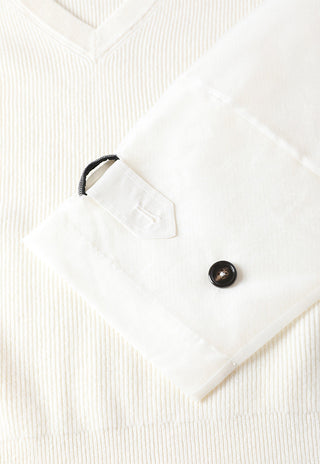 White organza sleeve tab and round button on ribbed wool knit cuff