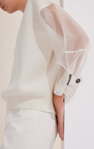 White wool knit top with V-neck; sheer organza sleeve cuff with button detail