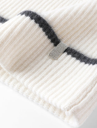 Cream ribbed cashmere beanie with bold black stripe across cuff.