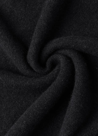 Dark grey cashmere knit fabric close-up with soft folded texture.