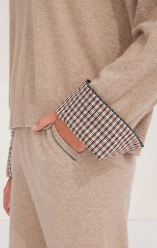 Camel sweater sleeve cuff detail: checked knit trim with navy-edged border