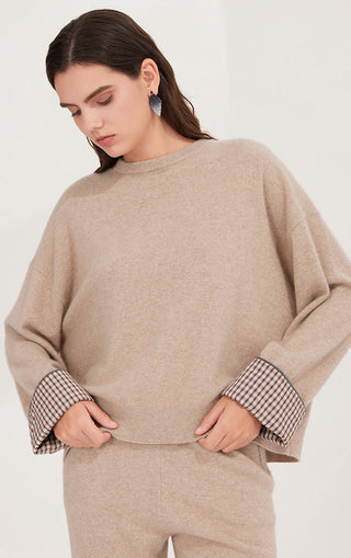 Camel cashmere relaxed knit sweater showing checked cuff detail on both sleeves