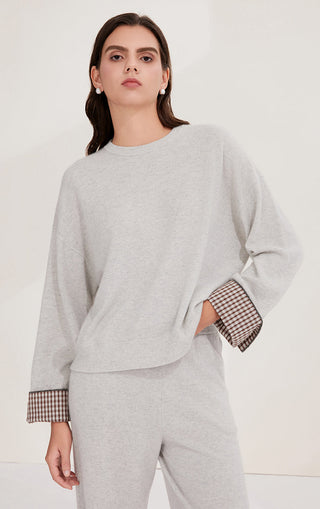 Light gray cashmere relaxed knit sweater with crew neck and checked cuff trim