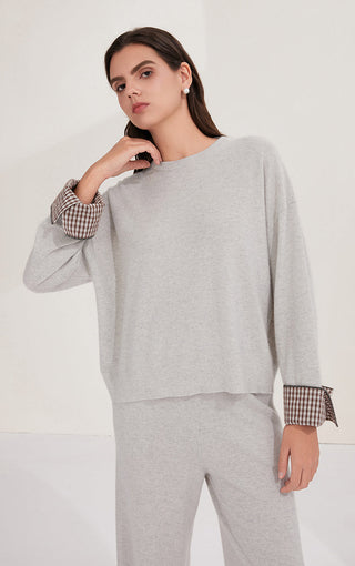 Light gray cashmere sweater with relaxed drape and checked cuff detail at hem sleeve