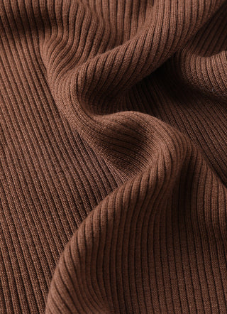 Brown ribbed wool sweater knit texture close-up at shoulder and fold.