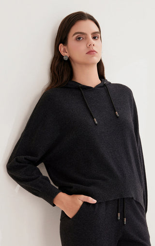 Black cashmere knit hoodie with drawstring cords and relaxed, draped neckline