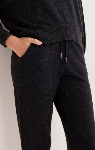Black knit pants close-up: side pocket and drawstring thread ties
