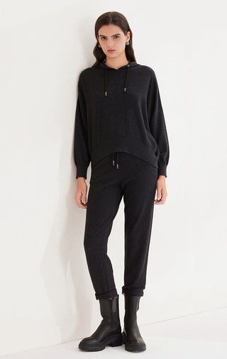 Black cashmere relaxed-fit knit pants on model, jogger-style cuffed hem