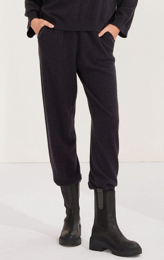 Black cashmere relaxed-fit pants with tapered legs and cuffed hem detail