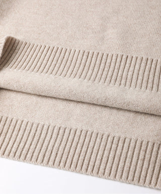 Camel wool sweater hem close-up with ribbed cuffs and knit texture