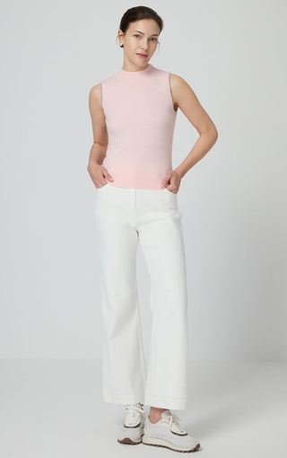 Light pink cashmere mock neck tank top styled with white wide-leg pants