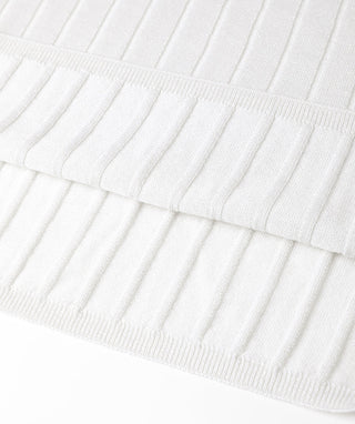 White ribbed lightweight turtleneck sweater, folded hem and knit texture detail.