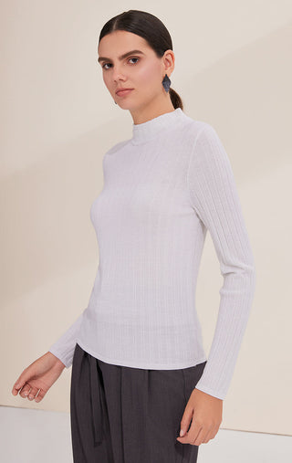 White lightweight wool ribbed turtleneck sweater, side view, long sleeves, close fit.