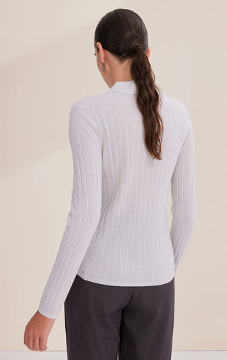 White wool ribbed turtleneck sweater, back view, vertical ribbing, long sleeves.