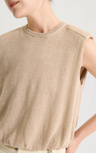 Close-up of camel sleeveless knit tank showing crew neck and tiny sequin sparkle