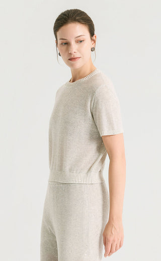 Light gray sequin short sleeve top, side view showing crew neckline and rib hem