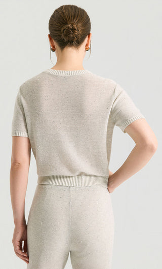 Back view of light gray sequin short-sleeve knit top with ribbed waist band