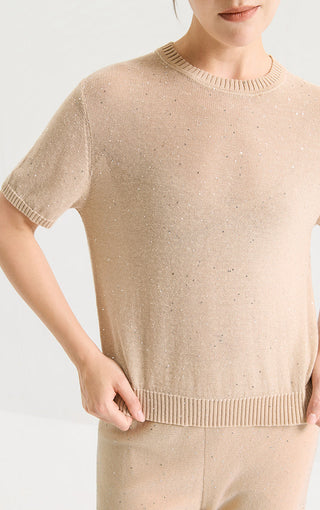 Close-up camel sequin knit short-sleeve top showing crew neck and ribbed hem