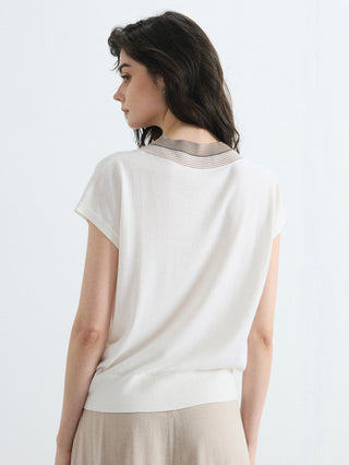 Ivory V-neck knit top, short sleeves, contrast trim visible at back collar