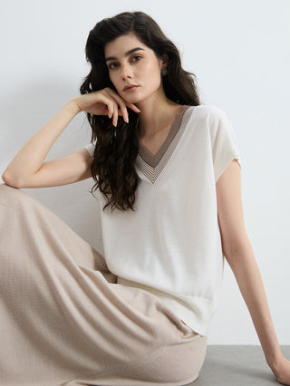 Ivory V-neck knit top with contrast trim at neckline; relaxed drape short sleeves