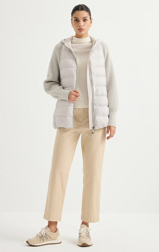 Light grey hooded puffer vest over ribbed knit sleeves, front pockets, full zip